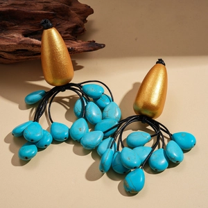 Ethnic bohemian drop earrings with gold metal top and turquoise blue beaded tassels