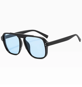 Detail view of black thick frame sunglasses with blue lenses and silver rivets at 45-degree angle