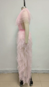 Detailed view of pink multi-layered mesh ruffles and lace hem on elegant long dress