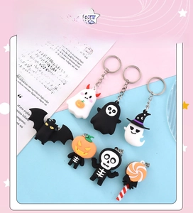 Flat lay of seven cartoon Halloween keychains including ghost, pumpkin and bat