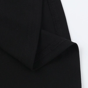 Detail shot of black knitted fabric with fine double-needle stitching and texture