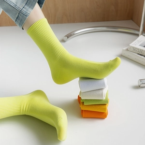 Vibrant candy colored ribbed cotton crew socks for women shown in a layered variety of hues