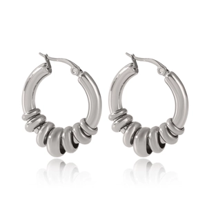 Detailed macro view of silver stainless steel hoop earrings with textured spiral band detail