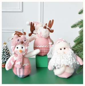 Pink and white plush Christmas ornaments including snowman, reindeer and Santa Claus dolls