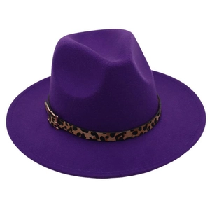 Detail of purple felt fedora hat featuring leopard print band and gold metal buckle