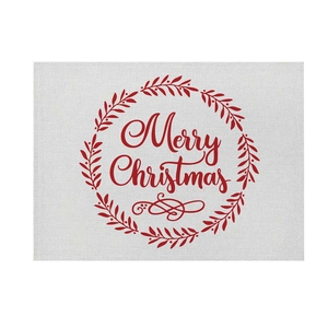 Detail showing red Christmas wreath print and Merry Christmas text on linen placemat