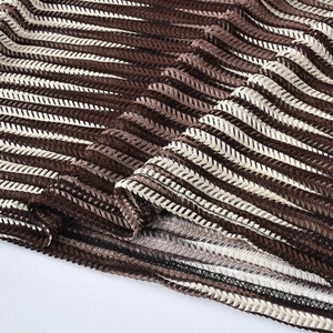 Macro detail of brown and white striped knit fabric with wave hollow mesh stitching