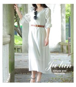Detail of white cotton midi dress with puff sleeves and brown PU leather belt accessory