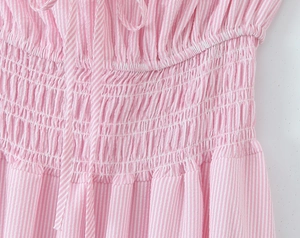 Detailed close-up of pink and white striped fabric with smocked elastic waist and drawstring