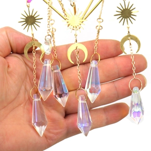 Close-up of golden sun and moon suncatcher with prismatic crystals and rainbow luster