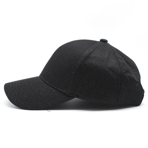 Detailed view of black sequins baseball cap with glittery texture and curved brim