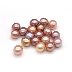 Macro shot of colorful irregular freshwater pearls in pink and purple for DIY jewelry