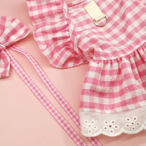 Detail of pink plaid pet dress with white lace trim and durable metal D-ring attachment