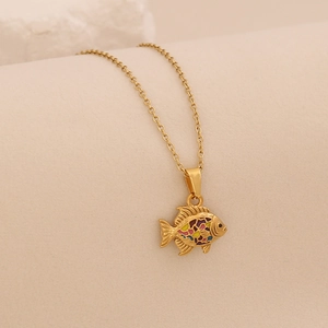 Close-up of golden fish pendant with colorful enamel inlay on a delicate chain