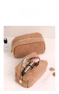 Detail view of caramel teddy fleece makeup bag interior showing storage and star pendant