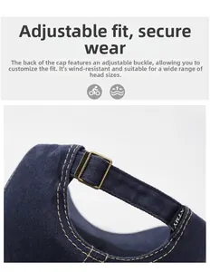 Detail view of navy denim baseball cap with adjustable metal buckle and contrast stitching