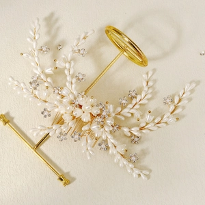 Elegant bridal hair comb with gold wires, white pearls, and rhinestones in flower leaf design