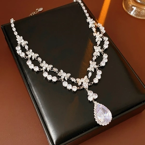 Detailed view of silver zircon floral necklace with pear-shaped teardrop pendant