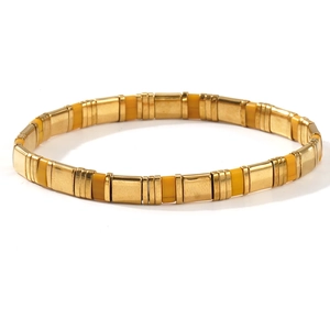 Bohemian Tila stretch bracelet featuring gold-tone beads and vibrant yellow enamel tiles