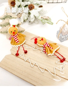 Close-up of cute gingerbread man ornaments with scarves on a festive wooden tray decor