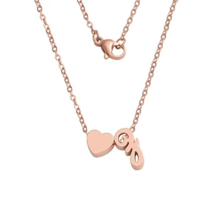 Detail of rose gold heart pendant and lowercase letter charm on a thin link chain