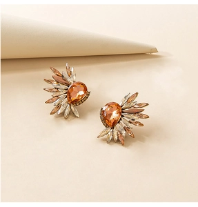 Detailed close-up of vintage amber water-drop crystal earrings with rhinestone halo