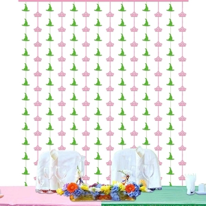 Pink crown and green witch hat patterns on party backdrop curtain for themed celebrations