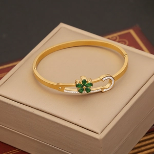 Elegant gold stainless steel bangle with green clover zircon flower and crystal accents