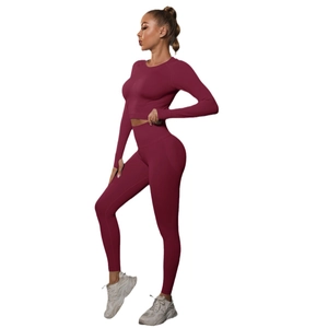 Seamless burgundy yoga set featuring long sleeve crop top and high waist leggings