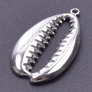 Detailed macro view of a polished silver cowrie shell pendant with top hanging loop