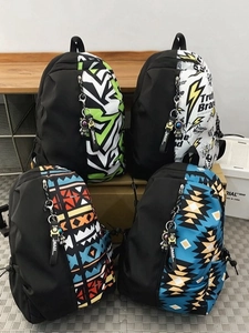 Four minimalist large-capacity school backpacks in various camouflage colorways