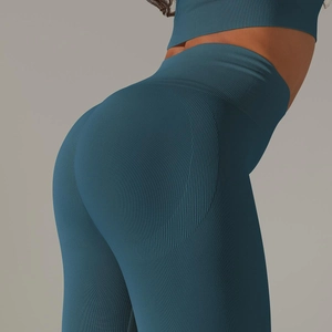 Close-up of seamless yoga leggings in teal with ribbed waist and breathable honeycomb texture