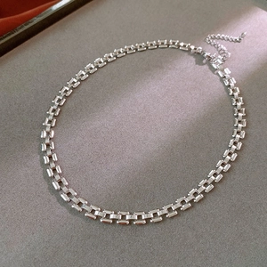 Detailed macro view of square link chain necklace with adjustable extender and silver finish
