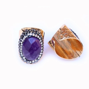Detailed macro view of vintage purple agate ring with rhinestone settings and gold finish