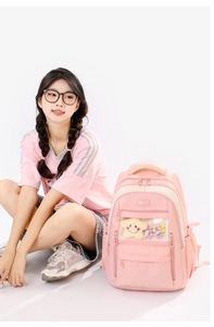 Pink school backpack with transparent window and multi-pocket design shown on model