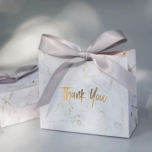 Elegant marble pattern gift bag with gold Thank You text and a grey satin ribbon bow