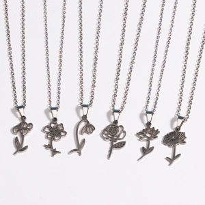 Detailed flat lay of six stainless steel necklaces featuring varied cutout flower pendants