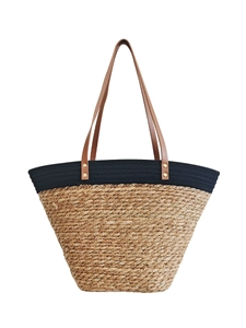 Handwoven straw tote bag with black trim and brown faux leather straps for beach holidays