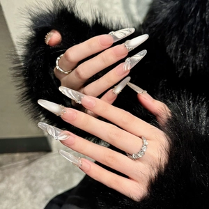 Detail of long trapezoidal press-on nails with 3D bows, silver beads and rhinestone accents