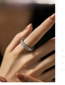 Detail shot of shimmering square-cut zircon row ring in sterling silver on finger