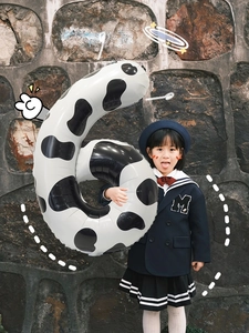 Detail of 40-inch cow print number 6 balloon with metallic finish for party decor