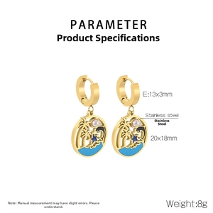 Detail view of gold stainless steel earrings with tropical palm tree and dolphin pendant
