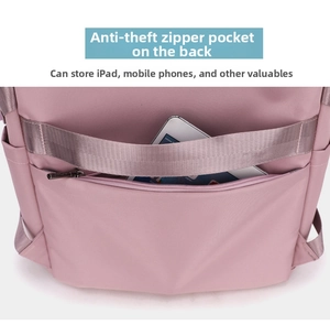 Pink travel backpack detail showing hidden anti-theft back pocket fitting an iPad