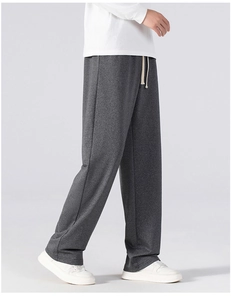 Detail of deep grey straight-leg trousers with high-quality fabric texture and waist drawstring