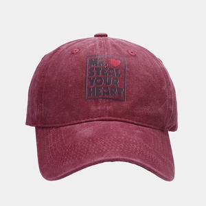 Detail of vintage washed burgundy cotton cap with Mr. Steal Your Heart print