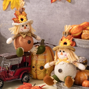 Close-up of scarecrow dolls and Harvest Blessings pumpkin for Thanksgiving decor