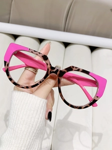 Close-up of cat-eye glasses frame in rose red and leopard print TR90 material
