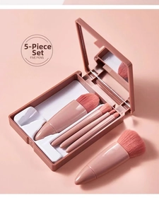 Detailed view of 5-piece travel makeup brush set in a pink portable mirror case