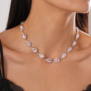 Elegant model wearing a luxury pink teardrop pendant necklace with sparkling diamonds