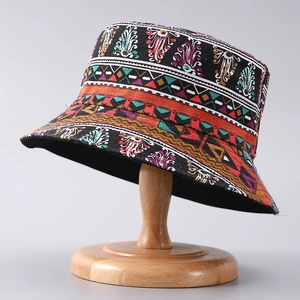 Ethnic style bucket hat with colorful palm tree and geometric prints on black canvas